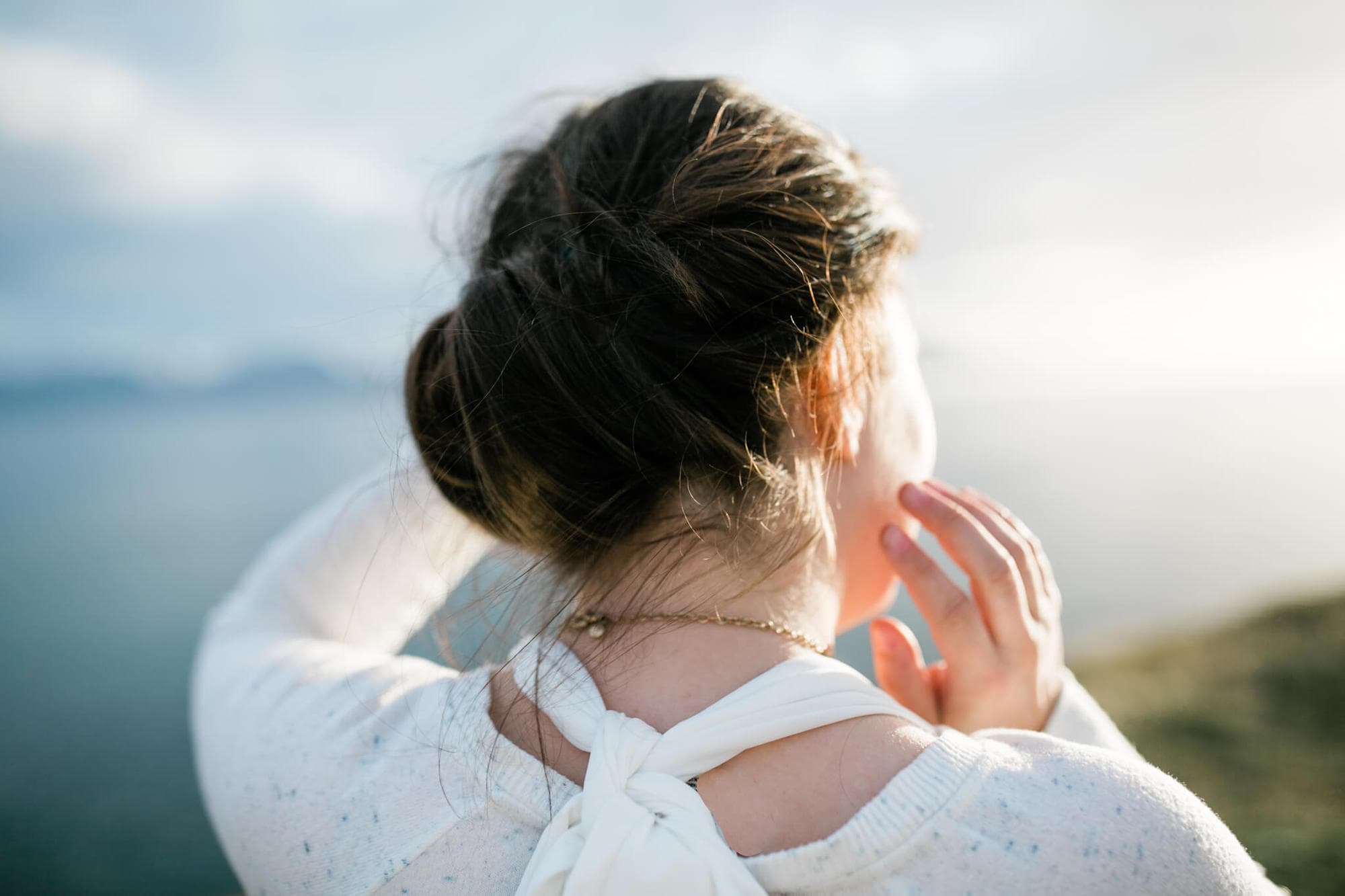 In the fading evening light a bride looks out over the sea in Iceland.