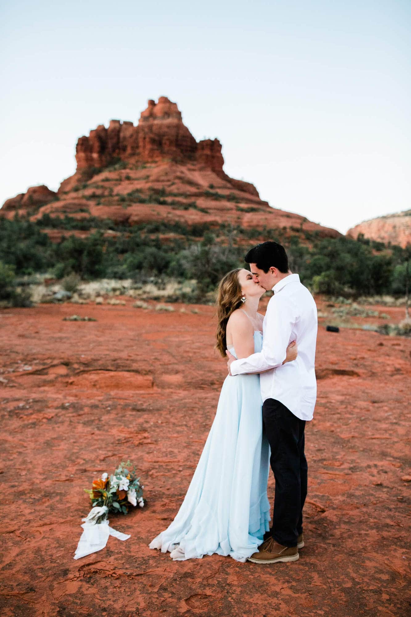 Having just eloped, the couple share their first kiss in front of Bell Rock in Sedona.
