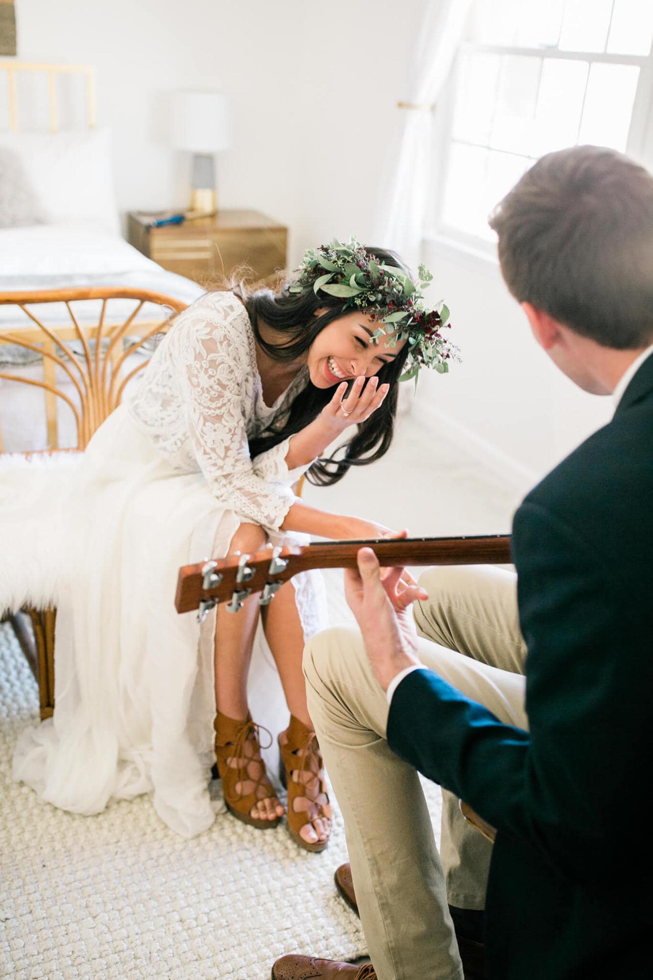 As her groom plays guitar, the bride giggles.