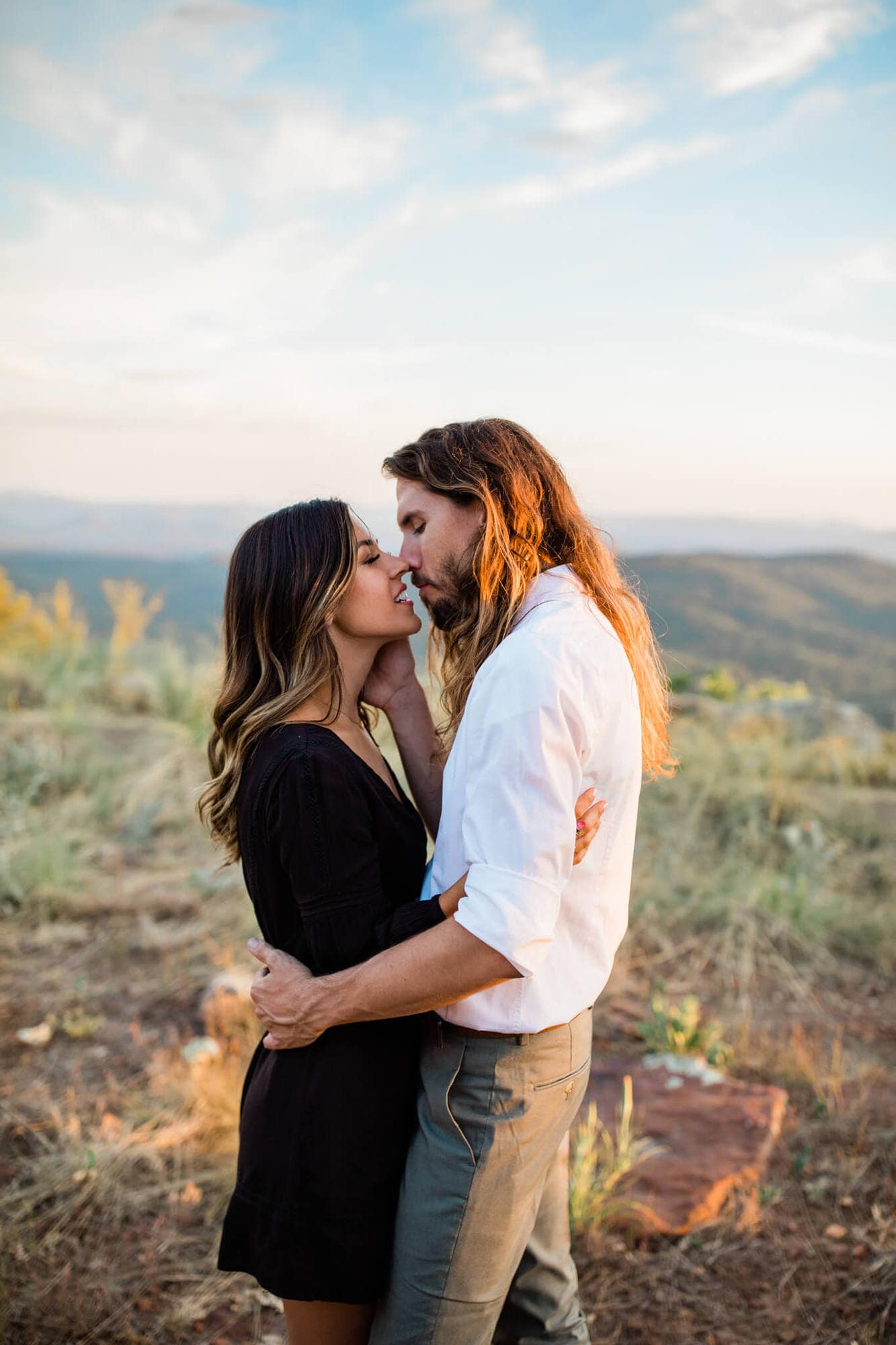 Leah and David stand at the edge of the Mogollon Rim for the epic forest engagement photos.