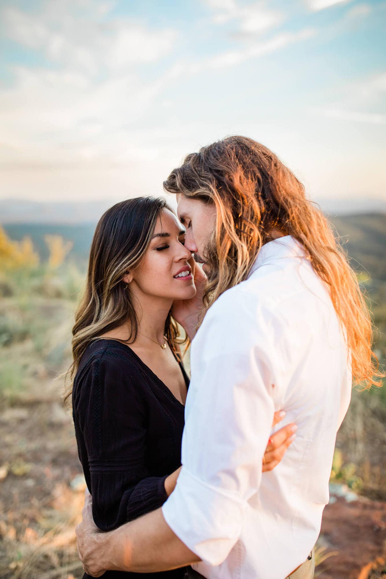 Leah and David snuggle in close during their forest engagement photos at the Mogollon Rim; the perfect spot for adventure and forest vibes.