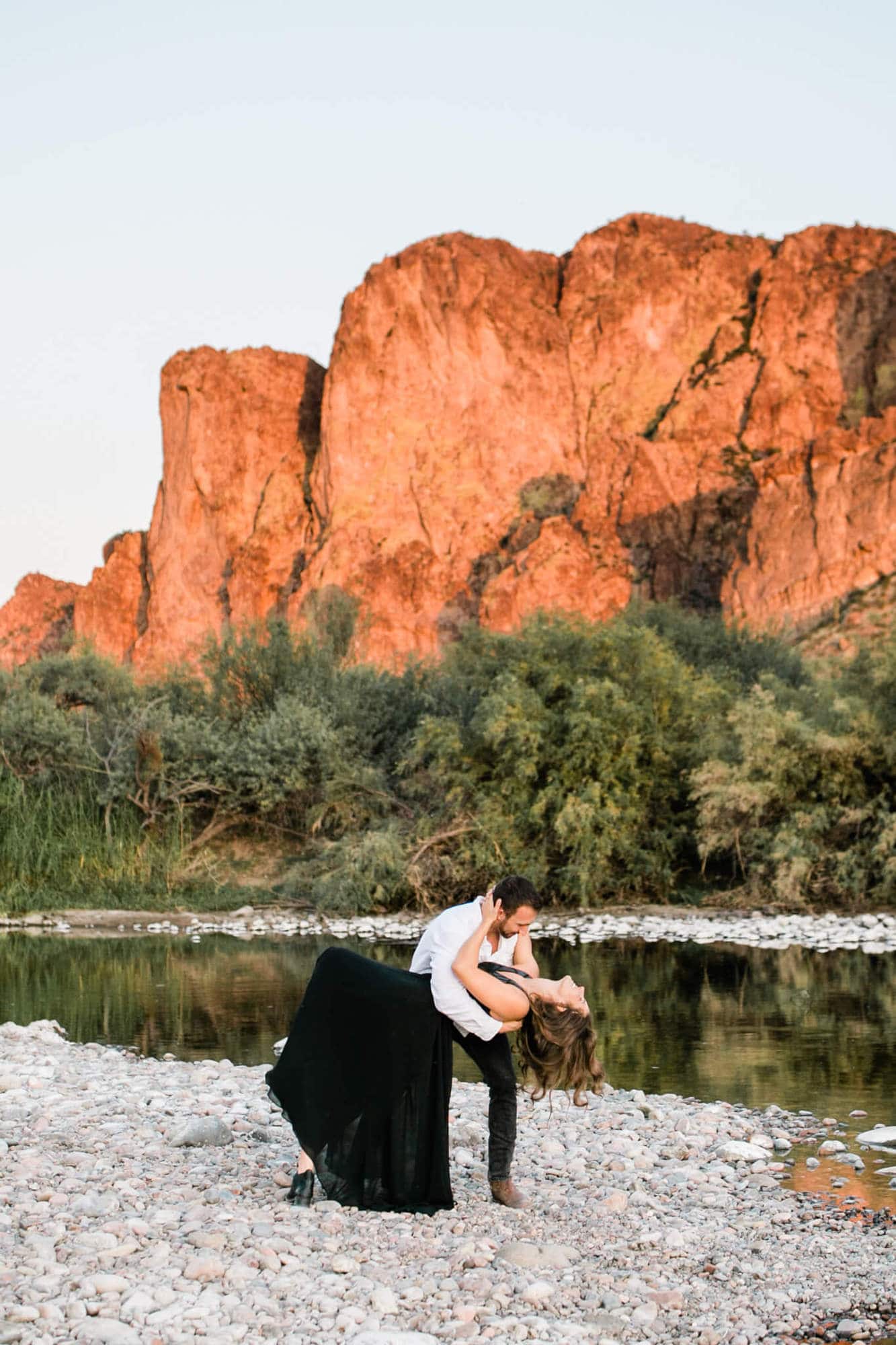 The adventurous couple dances in front of the Bulldog Cliffs. With the Salt River behind them, Logan dips Nicole.