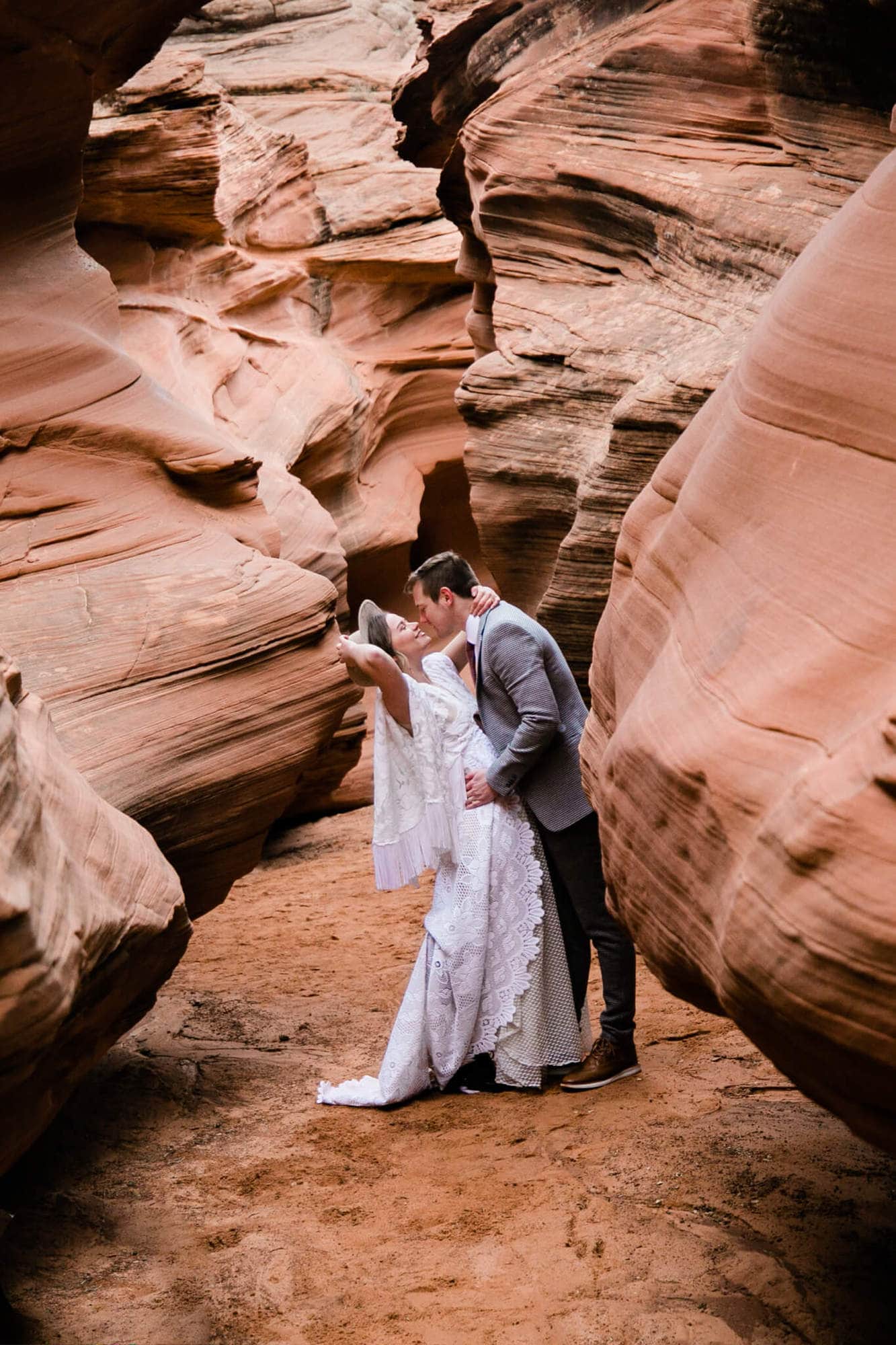 Bride and groom celebrate in the slot canyons of Page Arizona.