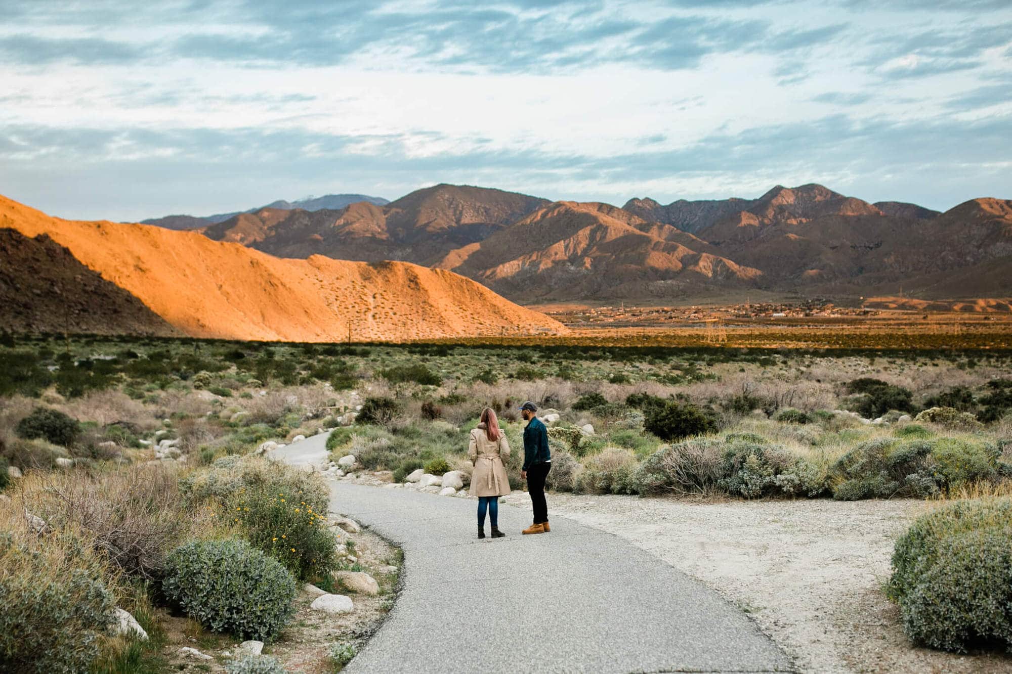 Couple looks out over California mountains for their engagement photos. 
