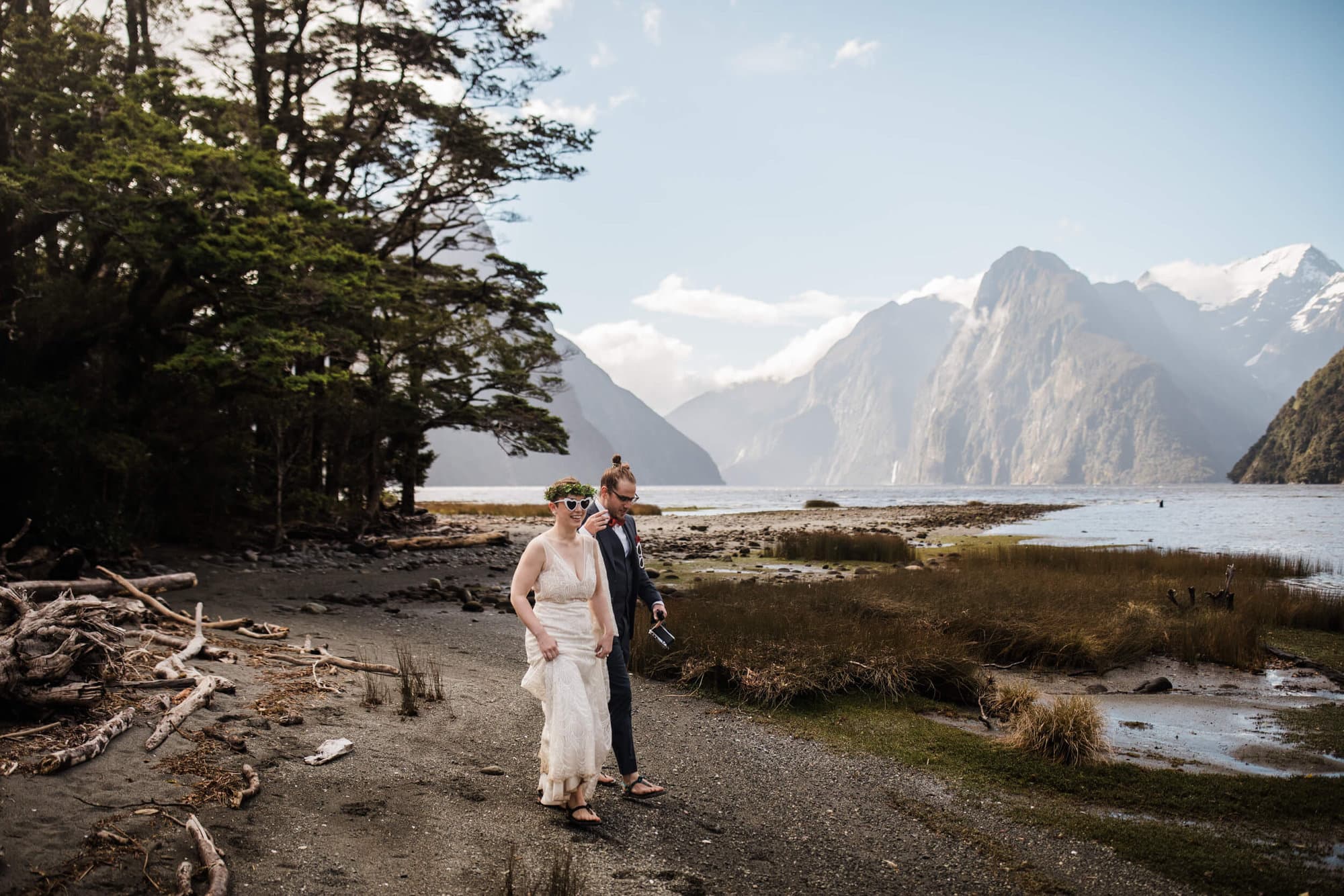 A couple hikes out to Milford Sound during their elopement. 