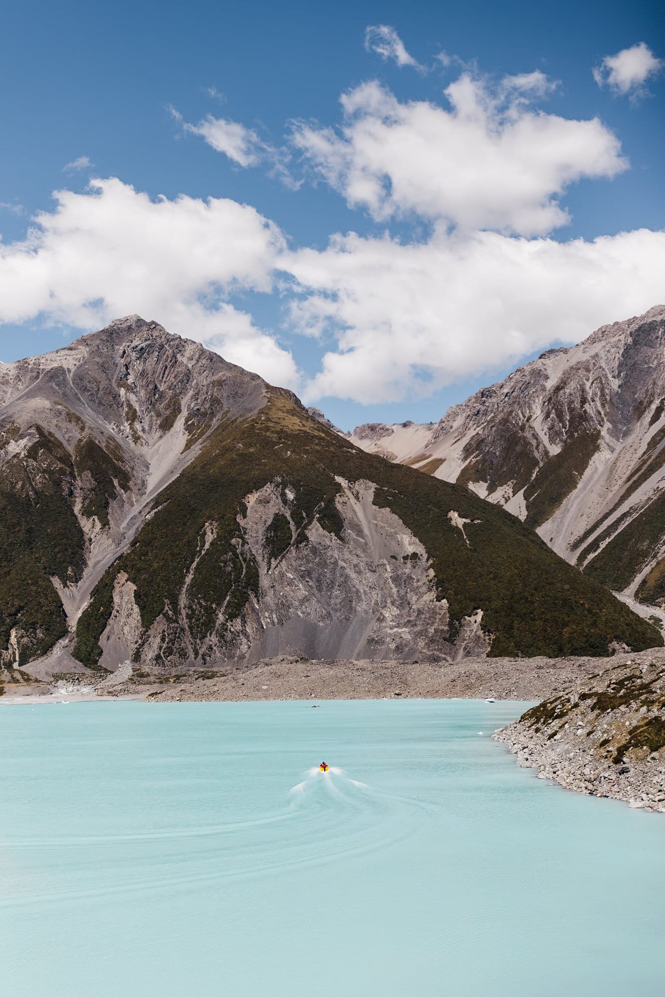 A boat on a turquoise lake in Mt Cook National Park. 