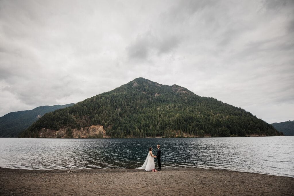 Bride and groom hold hands during their Lake Crescent elopement in Olympic National Park