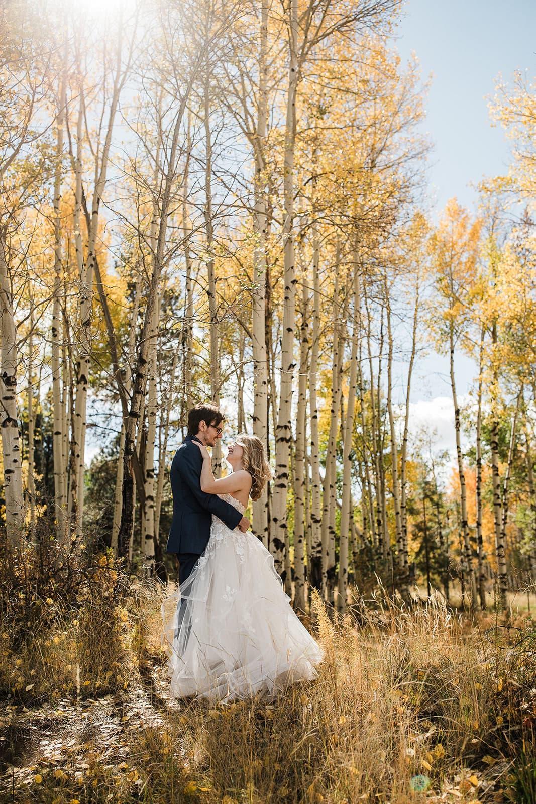 newlyweds kissing under a grove of aspen trees during their flagstaff elopement.
