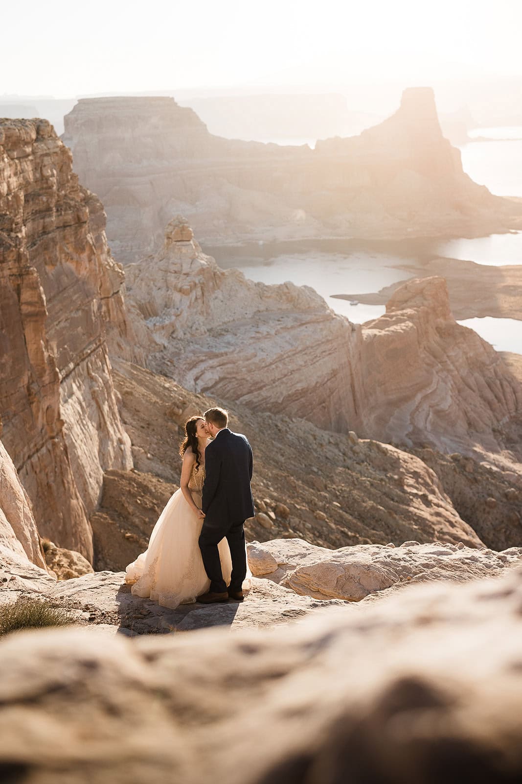 newlyweds kissing at the edge of a canyon in northern Arizona.