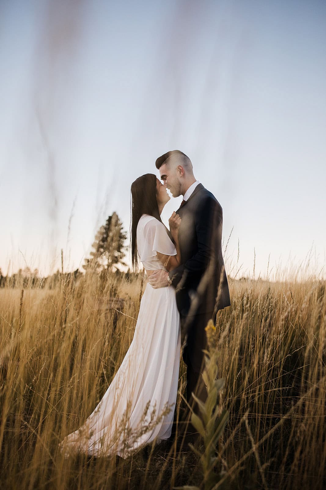 newlyweds kissing in a field outside of Flagstaff as they elope in Arizona