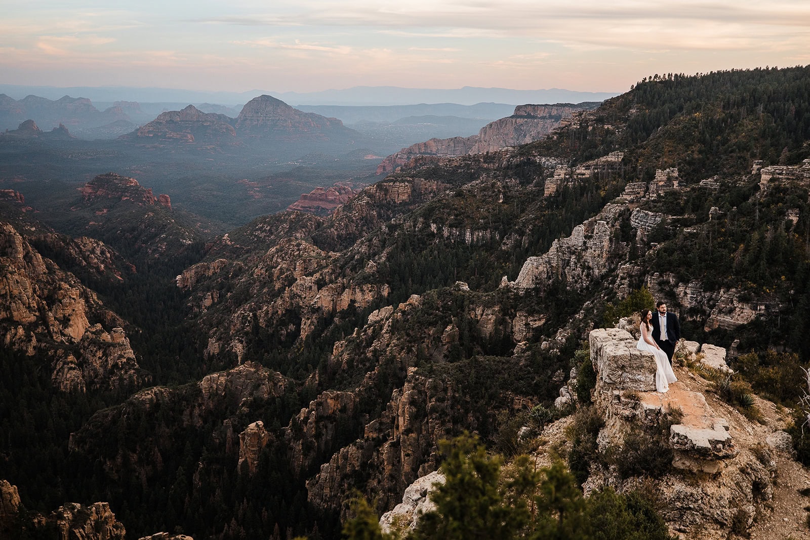 newlyweds sitting at the edge of the world during their flagstaff elopement.
