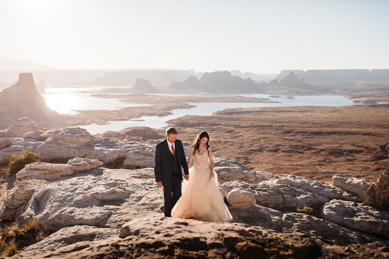 newlyweds holding hands exploring northern Arizona canyons during their elopement.