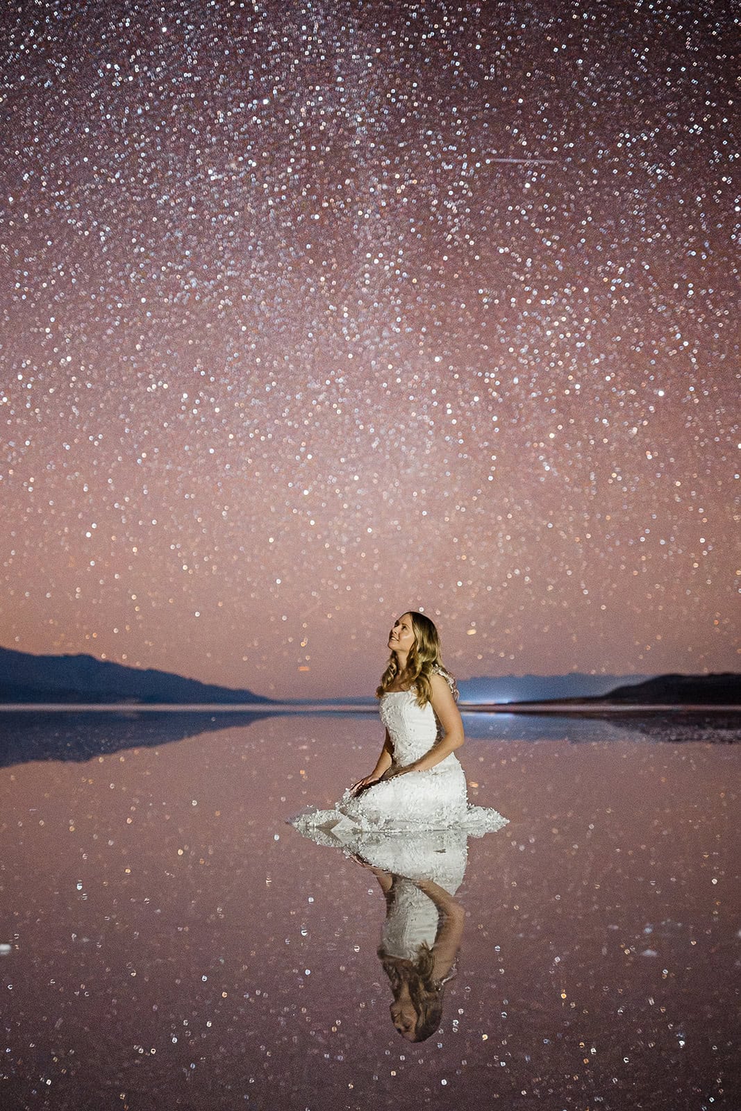 bride kneeling in lake manly in Death Valley.