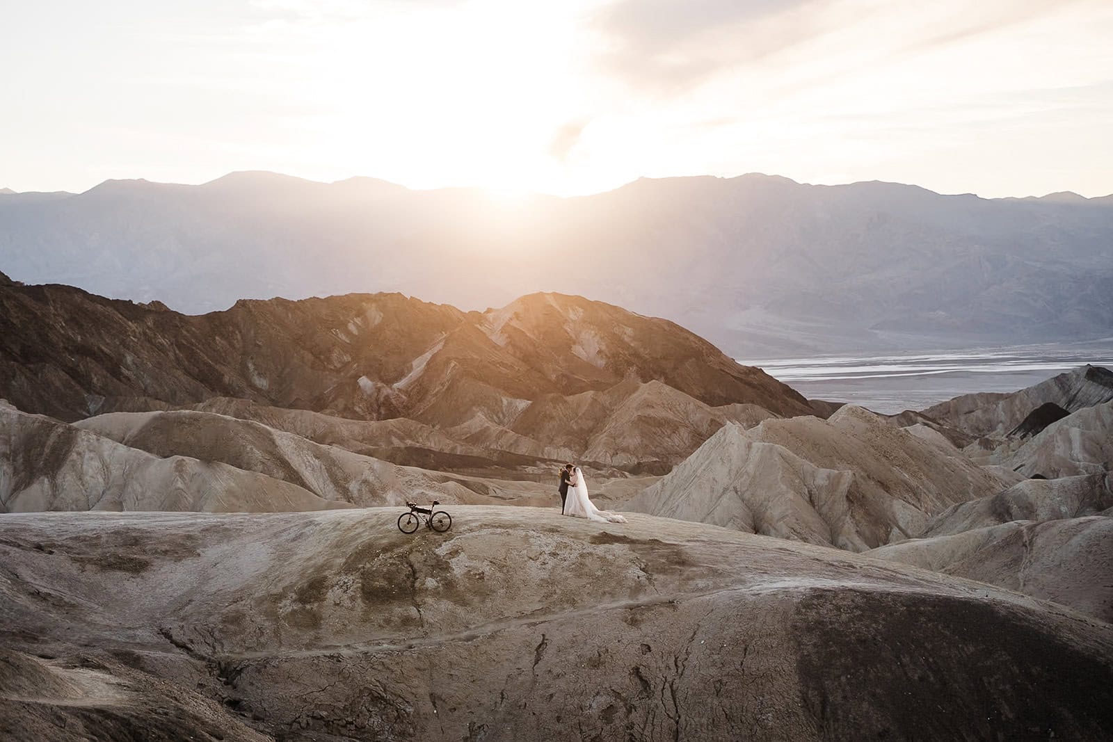 newlyweds kissing on Zabriskie Point as they elope in Death Valley.