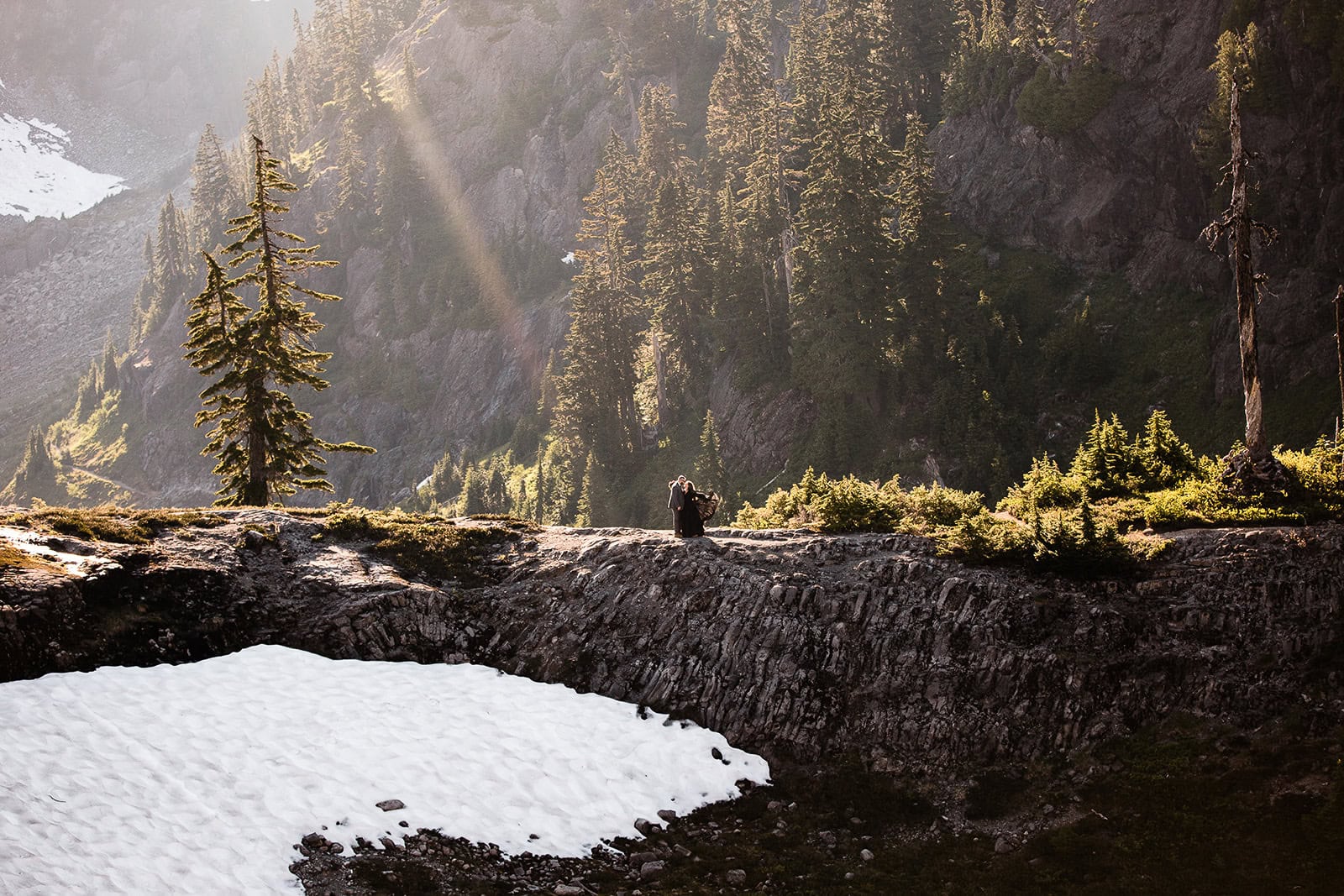newlyweds hugging in the mountains as they elope in Washington.