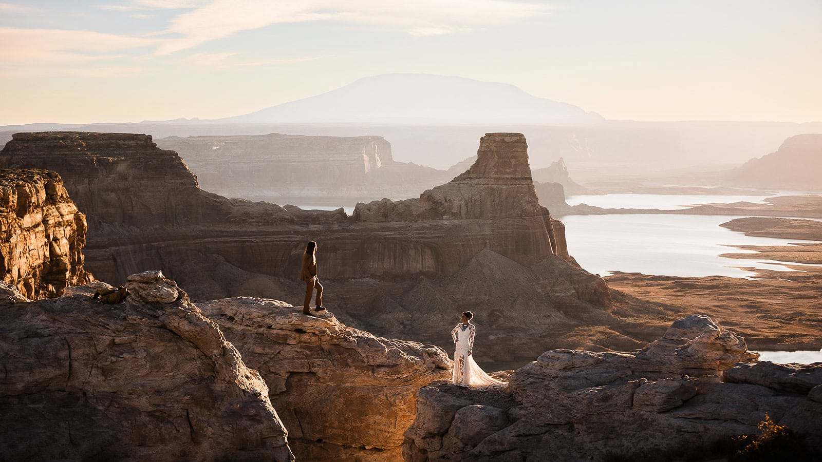newlyweds standing at the edge of a canyon.