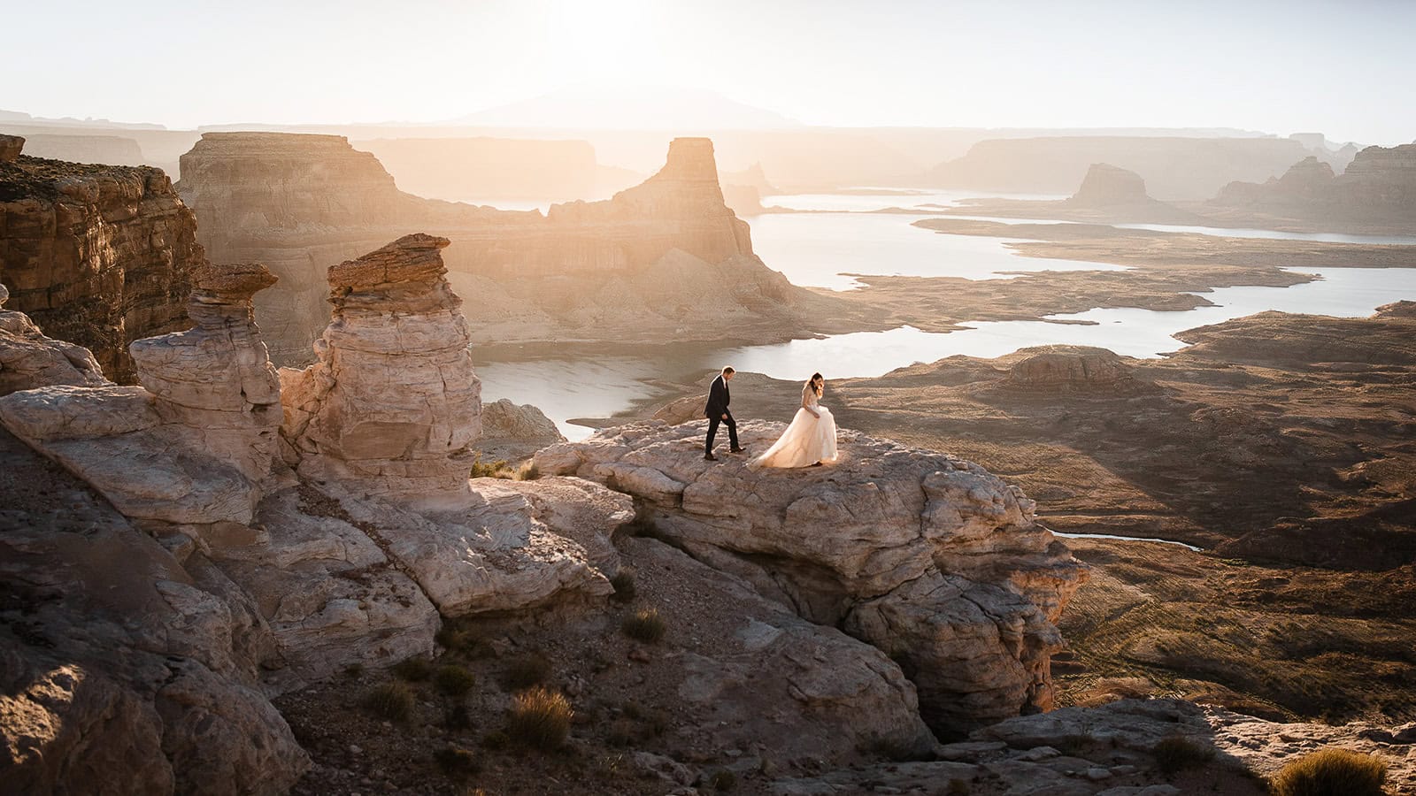 newlyweds standing on the edge of a cliff after getting their marriage license in arizona.
