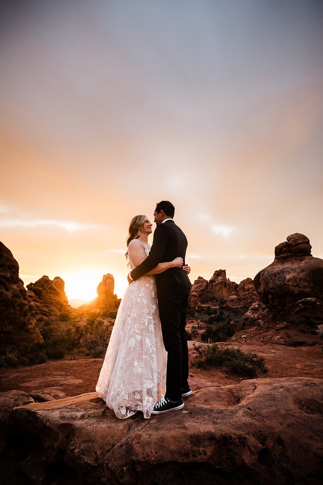 newlyweds hugging during golden hour in Moab.