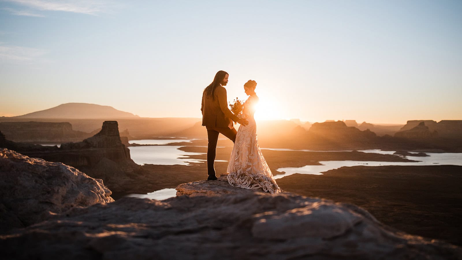 newlyweds standing at the edge of a canyon after getting their marriage license in arizona.