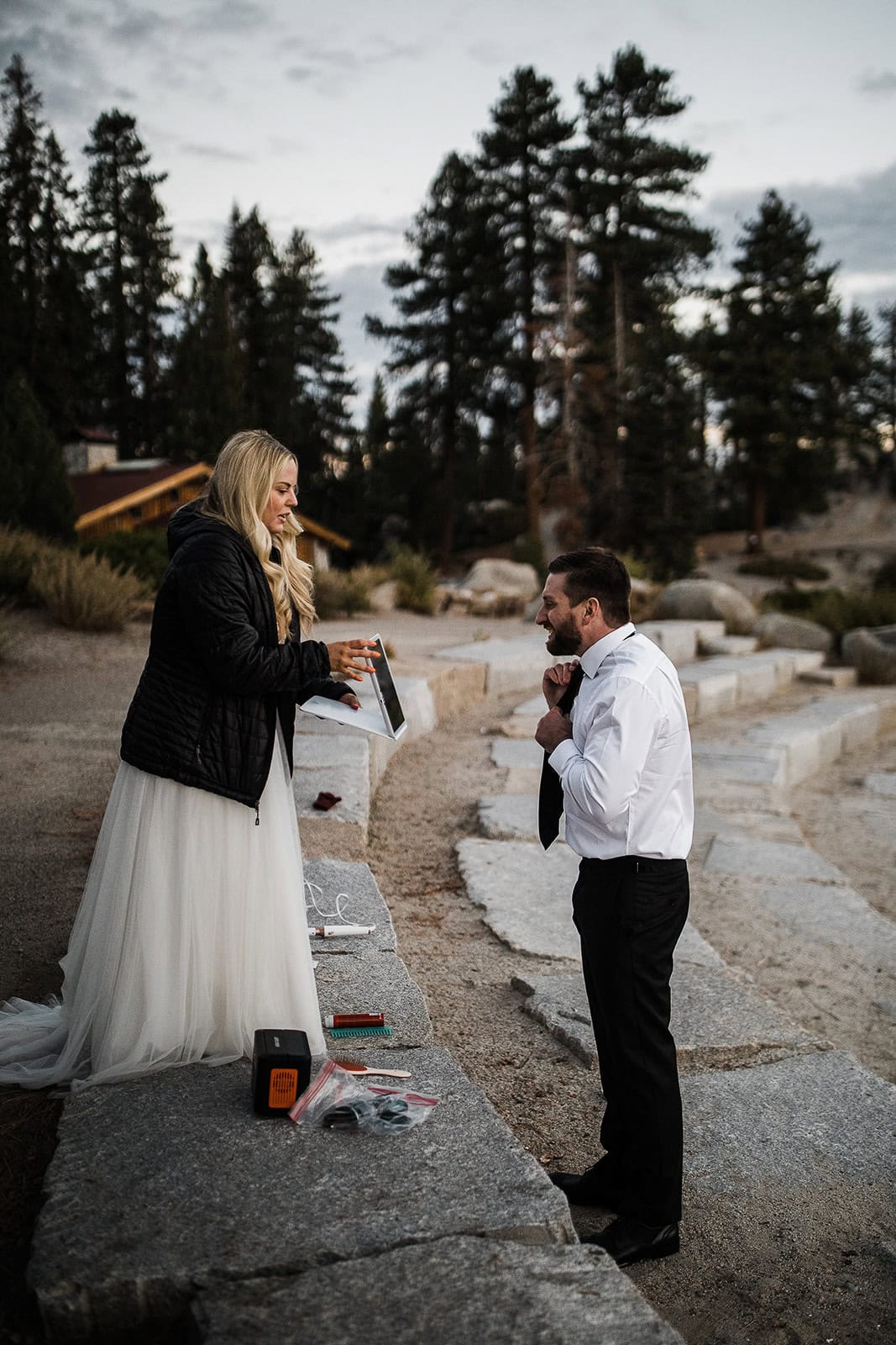 the groom adjusting his tie before his elopement.