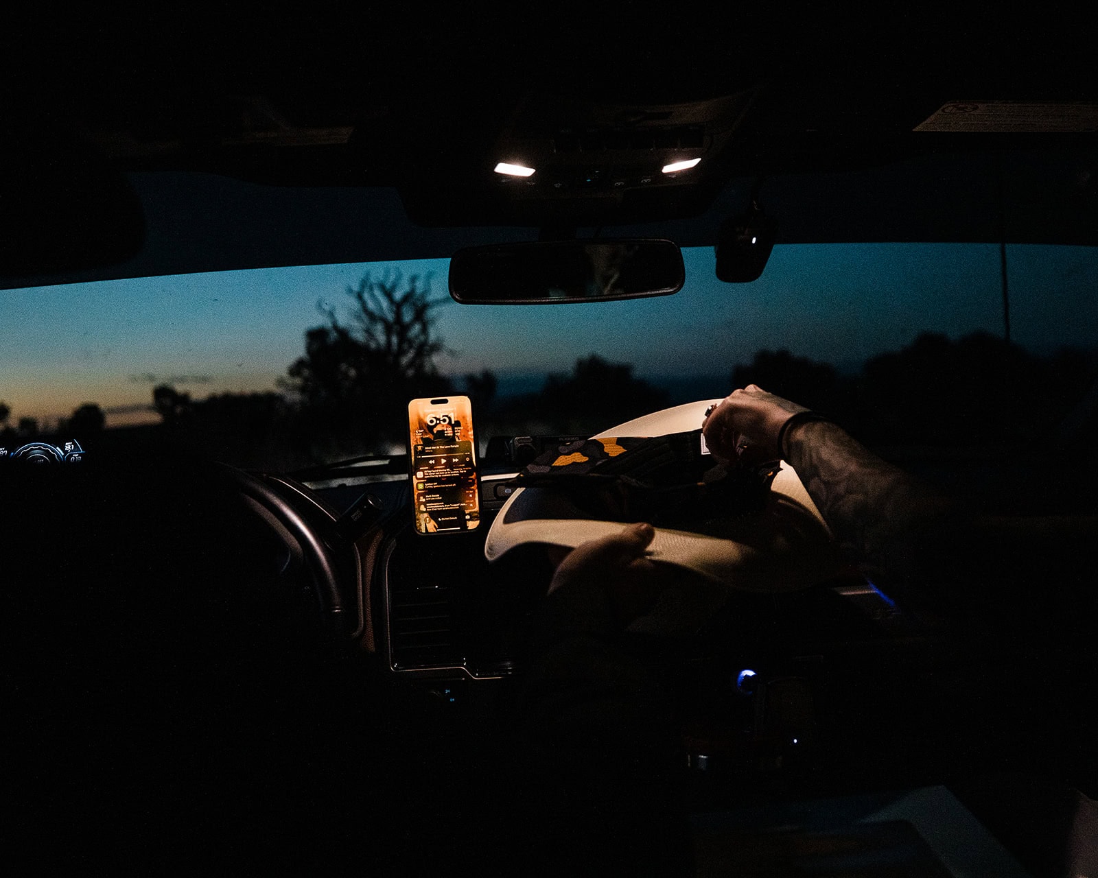 a couple driving in a car to a viewpoint at pre-dawn.