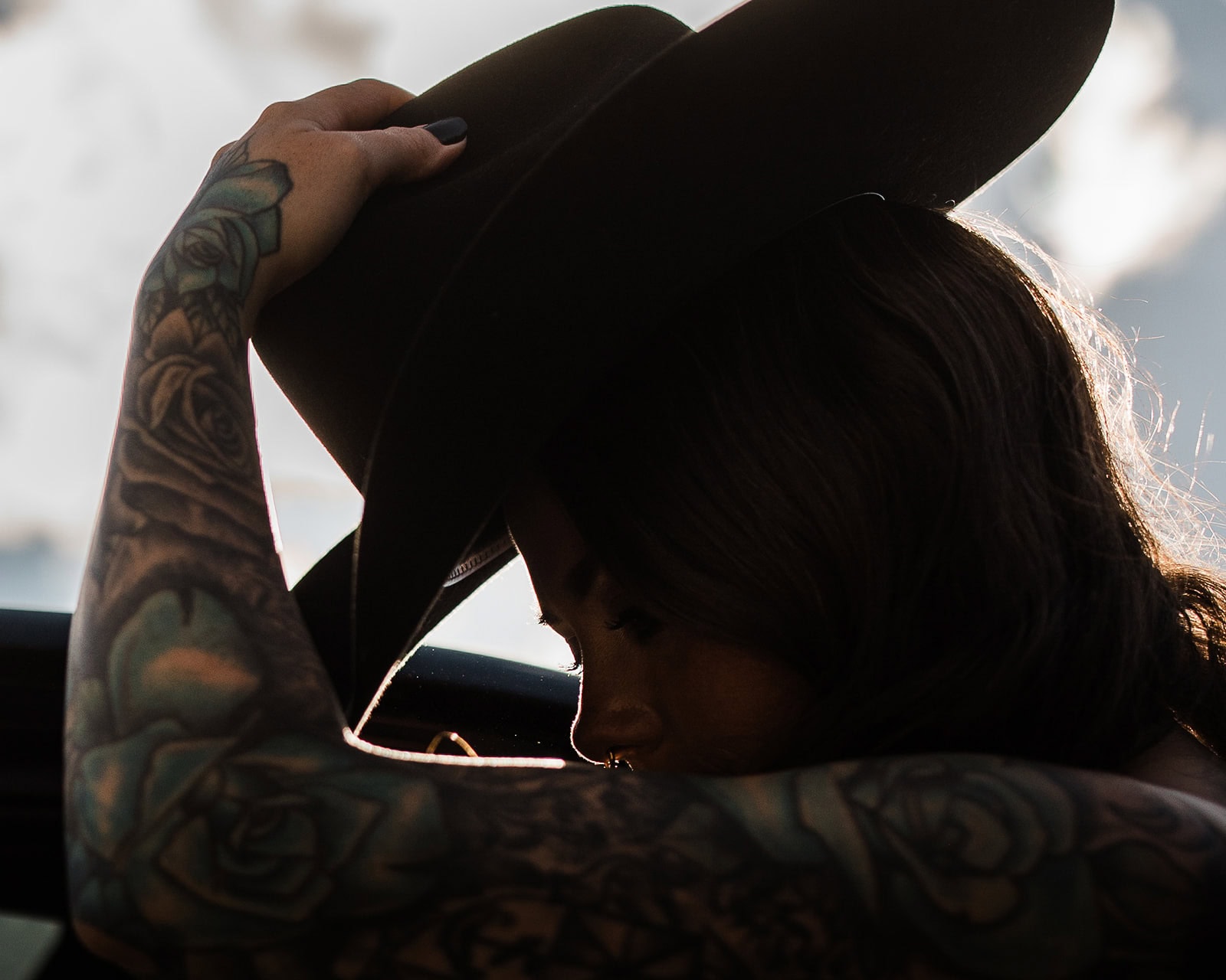 the bride taking off her cowboy hat.