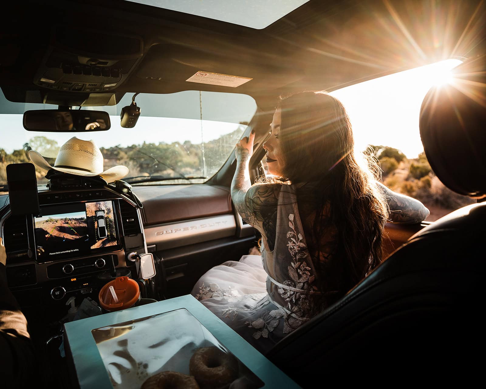 the bride sitting in the passenger seat of a truck.