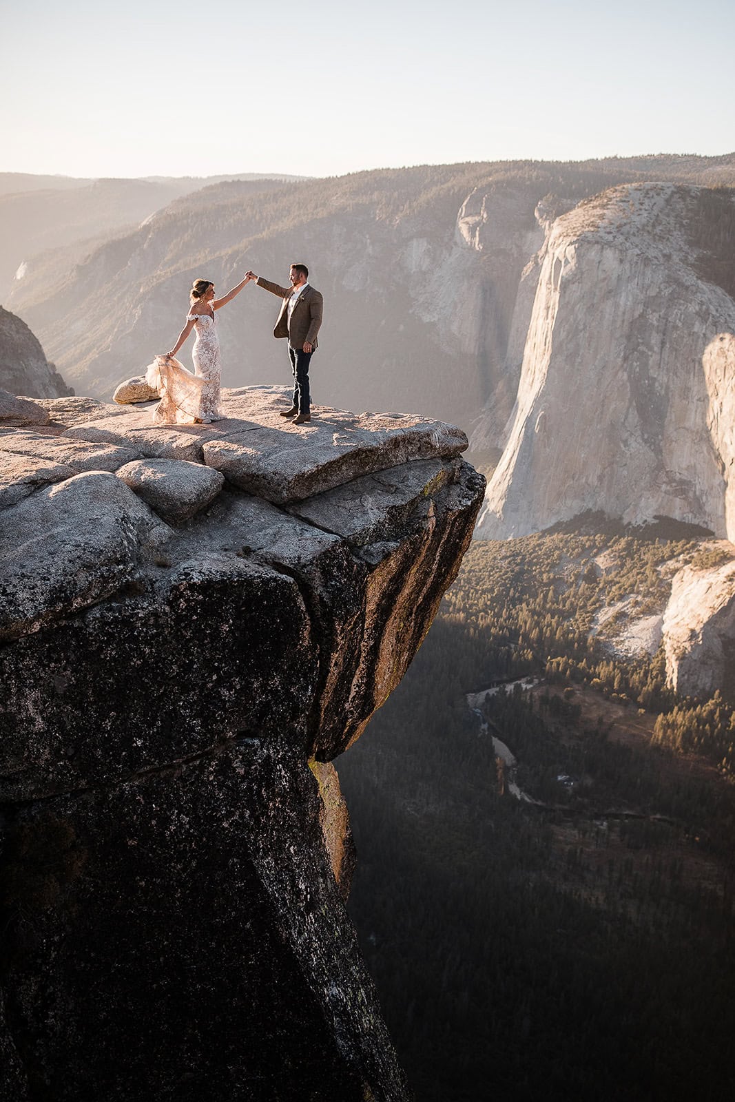 newlyweds holding hands at Taft Point during their Yosemite micro wedding.