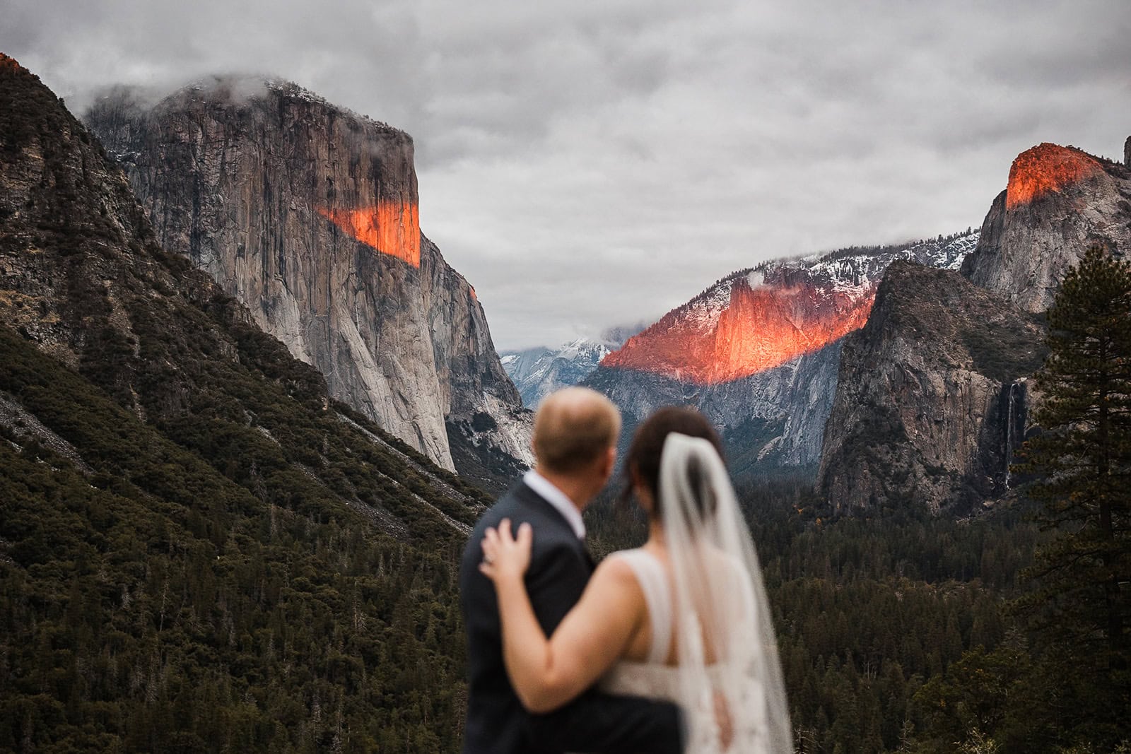 Newlyweds soaking in tunnel view during golden hour.