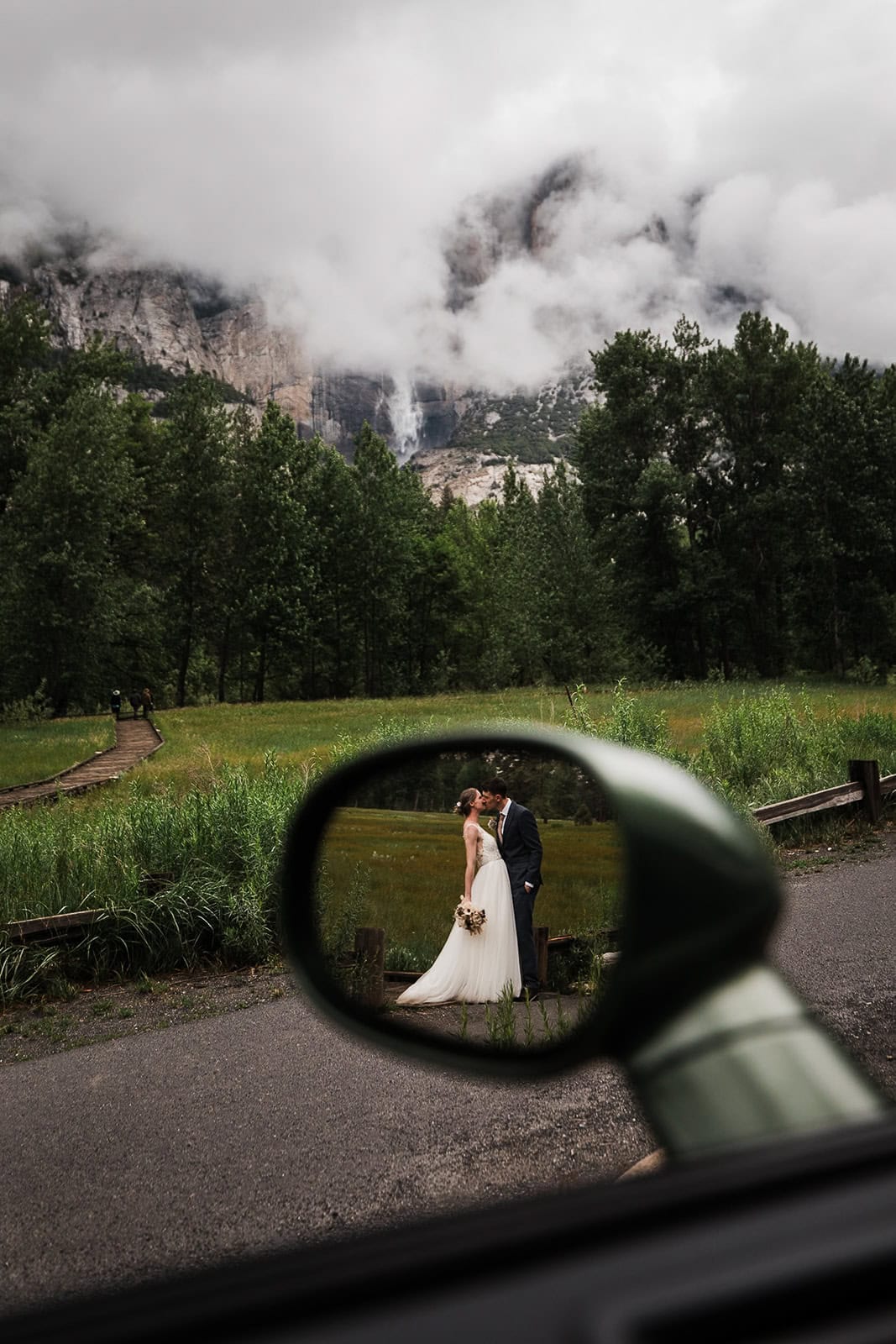 newlyweds kissing in a meadow in Yosemite.