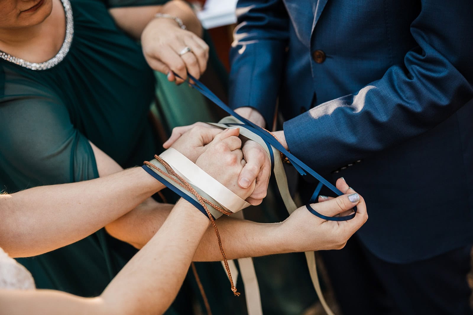 newlyweds performing a hand fasting ceremony during their elopement.