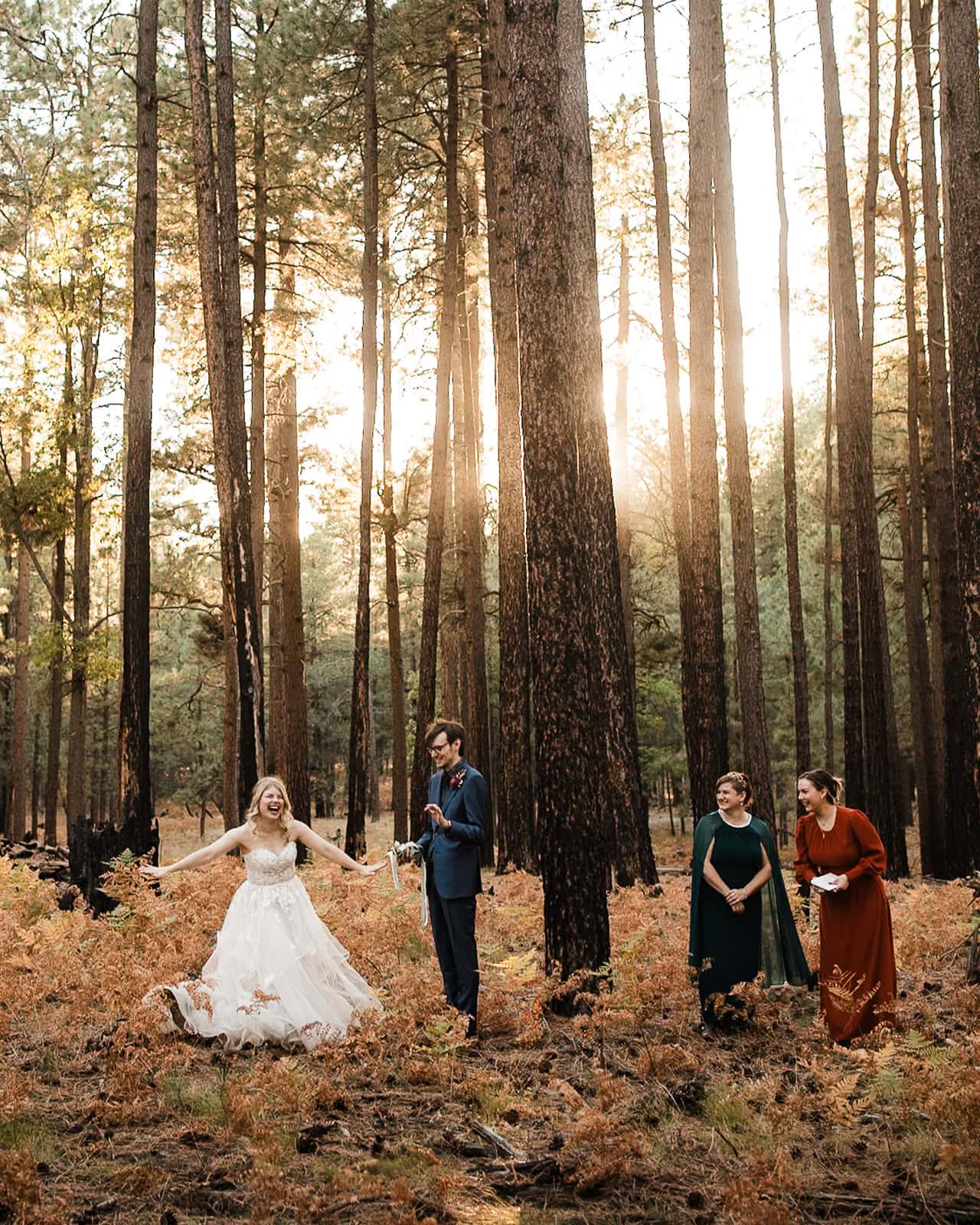 Newlyweds holding their elopement ceremony in a forest at fall.